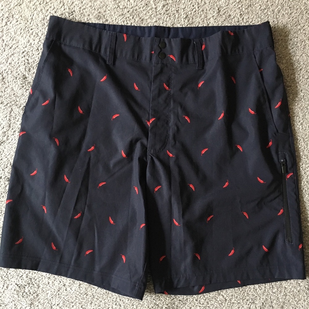 Navy blue golf shorts with red pepper pattern